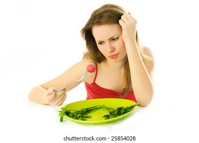 Beautiful Displeased Young Woman Keeping A Strict Diet And Eating Vegetables