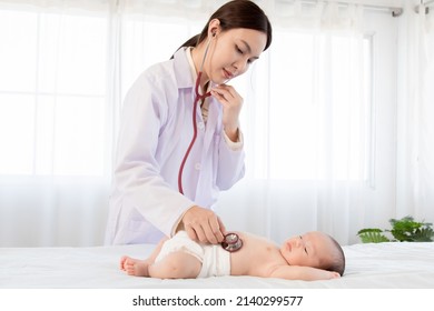 Beautiful Doctor Hand Using Stethoscope Examining Adorable Infant Heart, Asian Newborn Baby Get Sick Sleep During Examine By Pediatrician Hand Hold Stethoscope In Clinic.