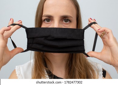 Beautiful Doctor Showing The Correct Way To Put On The Protection Mask. White Background
