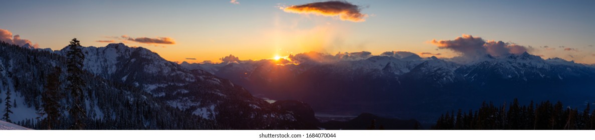 Beautiful Dramatic Canadian Mountain Landscape View during a sunny and cloudy winter sunset. Taken in Squamish, British Columbia, Canada. Nature Background Panorama - Powered by Shutterstock