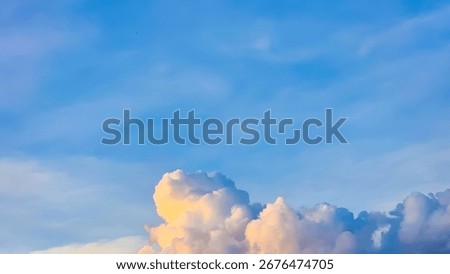Beautiful and dramatic clouds illuminated by the soft, warmlight of the setting sun, creating a peaceful and inspiring sky.
