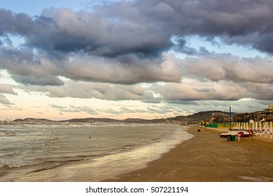 Beautiful dramatic cloudscape over the sea at sunset. Warm filter used. Falconara, Italy