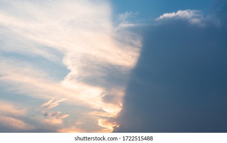 Beautiful dramatic gray and white clouds on blue sky, variety of shapes, silhouettes and shades at sunset time