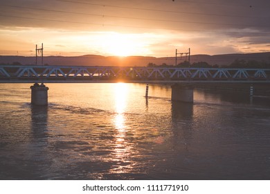 Beautiful dramatic sunset with bridge over river 