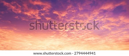 Beautiful and dramatic sunset sky filled with textured clouds. The gradient transitions from a bright golden yellow and warm orange at the bottom to a deep, rich purple and violet at the top. The scattered clouds create a dynamic texture across the horizon, capturing the natural beauty of a twilight evening or early dawn. This stunning colorful sky backdrop is ideal for nature, travel, inspirational concepts, and abstract artistic backgrounds.