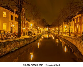 Beautiful dutch street lit up at night on a canal side in Amersfoort, Netherlands