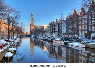 Beautiful early morning winter view on the Westerkerk and the Prinsengracht, one of the Unesco world heritage city canals of Amsterdam, The Netherlands. HDR