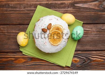 Beautiful Easter cake and eggs on wooden table, flat lay
