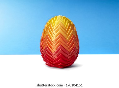 Beautiful easter egg on blue and white background. Copy space.
