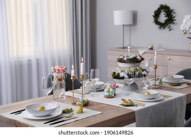 Beautiful Easter Table Setting With Burning Candles And Floral Decor Indoors