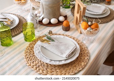 Beautiful Easter table setting with eggs and stylish dinnerware