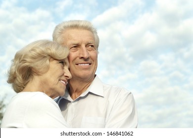 beautiful elderly couple  on the background of sky