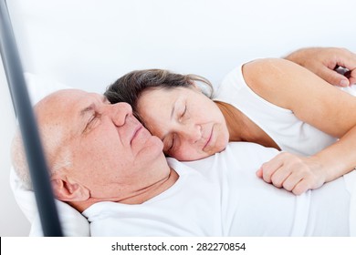 Beautiful Elderly Couple Sleeping In Bed.