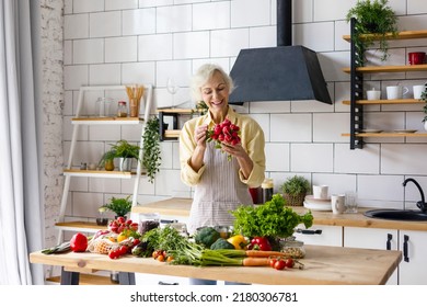 Beautiful Elderly Gray Haired Senior Woman Cook In Cozy Kitchen With Fresh Organic Vegetables, Tomatoes, Cabbage, Lettuce, Cucumbers On Table Cooking Healthy Vegetable Salad, Healthy Food Active Life