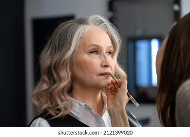 Beautiful elderly woman getting make-up in a beauty salon - Powered by Shutterstock