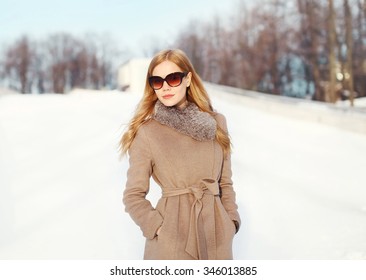 Beautiful Elegant Blonde Woman Wearing A Coat Jacket And Sunglasses In Winter City