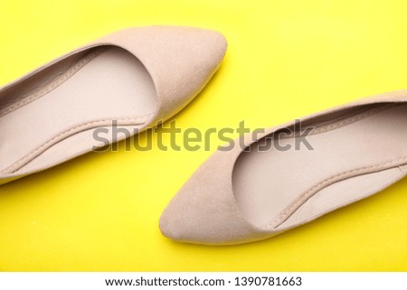 Beautiful elegant classic fashionable spring women's suede shoes on bright yellow background. Top view.