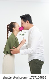 Beautiful Elegant Couple Is Kissing Behind Roses