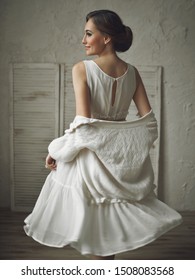 Beautiful elegant girl in a white dress. Pretty woman in fluttering dress