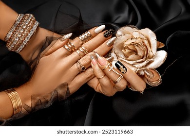 Beautiful elegant manicure on black satin background. Manicure and nails concept. Trendy nails.