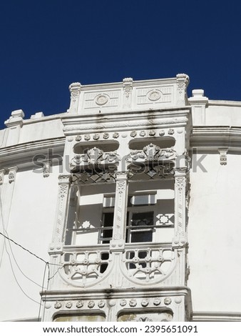 A beautiful and elegant Moroccan whitebuilding with Spanish and Arab influence style contrasting with a deep blue sky