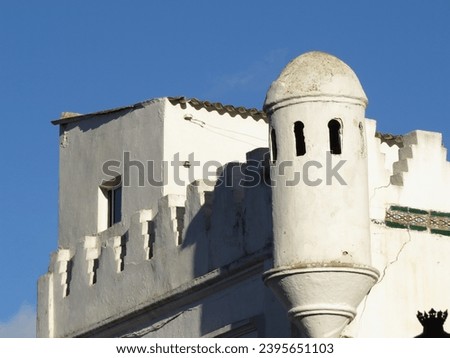 A beautiful and elegant Moroccan whitebuilding with Spanish and Arab influence style contrasting with a deep blue sky