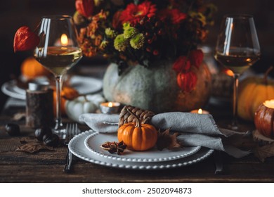 Beautiful elegant table setting for candlelight Thanksgiving Day dinner or Halloween party at home. Fancy dishware, porcelain plates. Floral centrepiece, pumpkins and burning candles as decor - Powered by Shutterstock