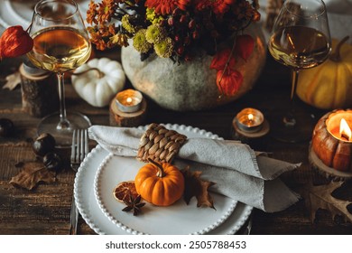 Beautiful elegant table setting for candlelight Thanksgiving Day dinner or Halloween party at home. Fancy dishware, porcelain plates. Floral centrepiece, pumpkins and burning candles as decor - Powered by Shutterstock