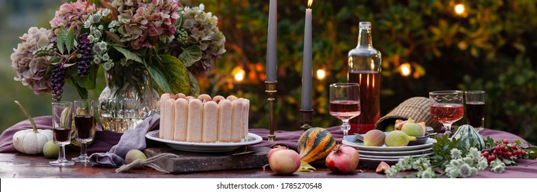 Beautiful And Elegant Table Setting For A Romantic Date For A Couple. Delicious Meal, Tasty Dessert. Private Terrace Outside The Restaurant. Lights On The Tree On Background. Italy, Tuscany. Banner