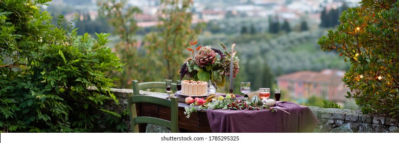 Beautiful And Elegant Table Setting For A Romantic Date For A Couple. Delicious Meal, Tasty Dessert. Private Terrace Outside The Restaurant. Lights On The Tree On Background. Italy, Tuscany. Banner