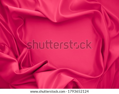 Beautiful elegant wavy fuchsia pink satin silk luxury cloth fabric texture, abstarct background design. 