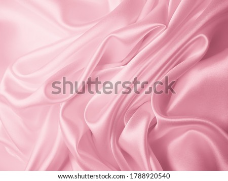 Beautiful elegant wavy light pink satin silk luxury cloth fabric texture, abstract background design. 