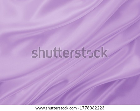 Beautiful elegant wavy light violet or purple satin silk. Luxury fabric texture, abstract background design. Card or banner.