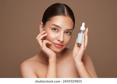 Beautiful elegant woman holding a cosmetic jar of oil serum or hyaluronic acid in her hand. Perfect facial skin - Powered by Shutterstock