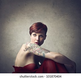 Beautiful Elegant Woman With A Tattoo On Her Arm