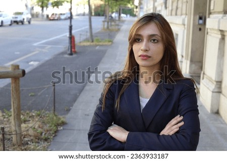 Beautiful elegant young woman posing on the street 