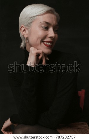 Beautiful emotional girl with white hair on a black background
