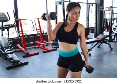 Beautiful Empowered Woman Poses While Exercising Lifting Dumbbel