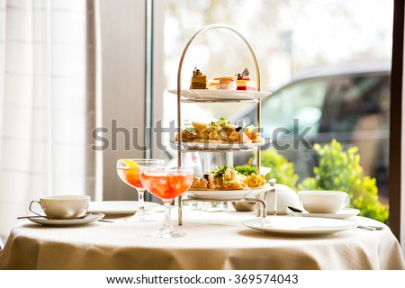 Beautiful english afternoon tea ceremony with desserts and snacks