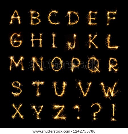 Beautiful english alphabet. Burning sparkler letters isolated on black background. Shiny festive font of Sparklers to overlay on texture for design Holiday postcards, web banners