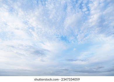 Beautiful epic soft gentle blue sky with white and grey cirrus and fluffy clouds background texture - Shutterstock ID 2347334059