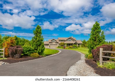 Beautiful estate home on large acreage with lush landscaping, split rail fence and long asphalt paved driveway