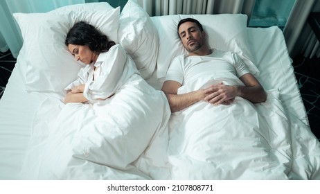 Beautiful Ethnic Couple Laying In Bed Under The Blanket Awake In A Fancy Hotel Room Suite. Girlfriend Mad At Her Boyfriend For Not Asking Her To Marry Him On Valentines Day, Celebrating It Together.