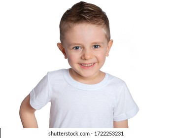 A Beautiful European Boy In A White T-shirt On A White Background. A Blue-eyed Child Of Five Years Old Smiles And Laughs. Children's Emotions.