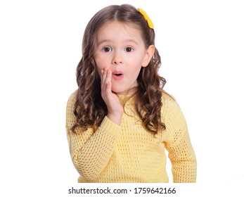 A beautiful European girl is surprised. Portrait of a 4-year-old child on a white background. Children's emotions, gestures.