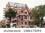 Beautiful european style building resembling an old castle called Villa Normandy among modern buildings. a mix of old and new style architecture