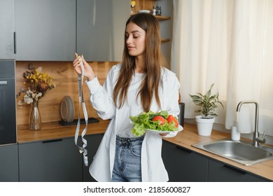 Beautiful European Woman Preparing A Toast Of Vegetables And Microgreens. Nutritionist Teaches Healthy Eating. The Vegetarian Diet Raw Food. Dinner Of Modern People. Cooking Sandwich. Girl Happy Cook