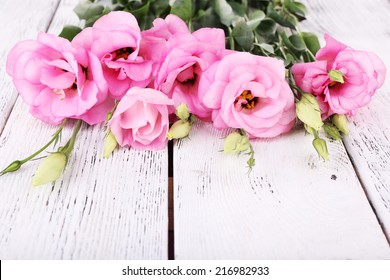Beautiful eustoma flowers on wooden background - Shutterstock ID 216982933
