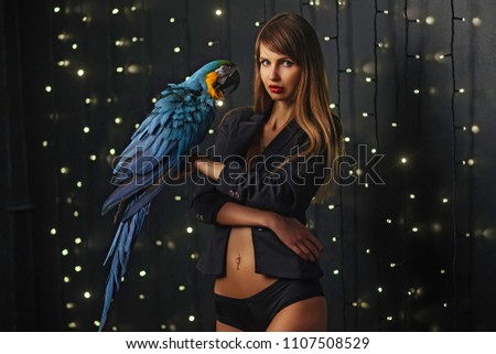 Beautiful evening photo shoot of a girl and her favorite charming parrot
