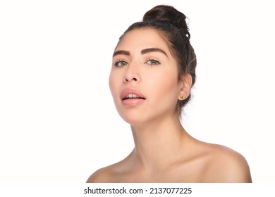 Beautiful exotic model with green eyes in beauty portrait. High fashion beauty and skin shoot in studio of latina or hispanic model with young and fresh skin. Shot on a white background.